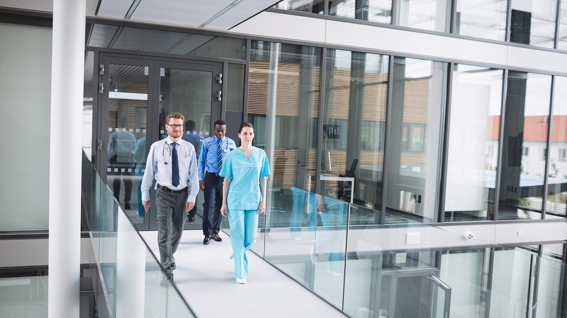 Doctors and nurse walking in corridor at hospital